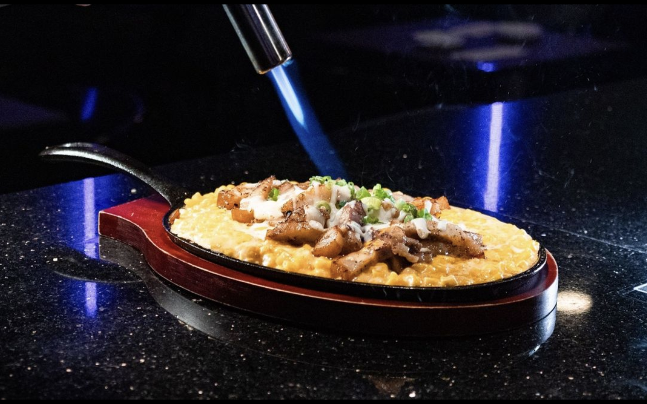The sizzling Corn Cheese, available with or without grilled pork belly, is a highlight at Tipsy Chicken.