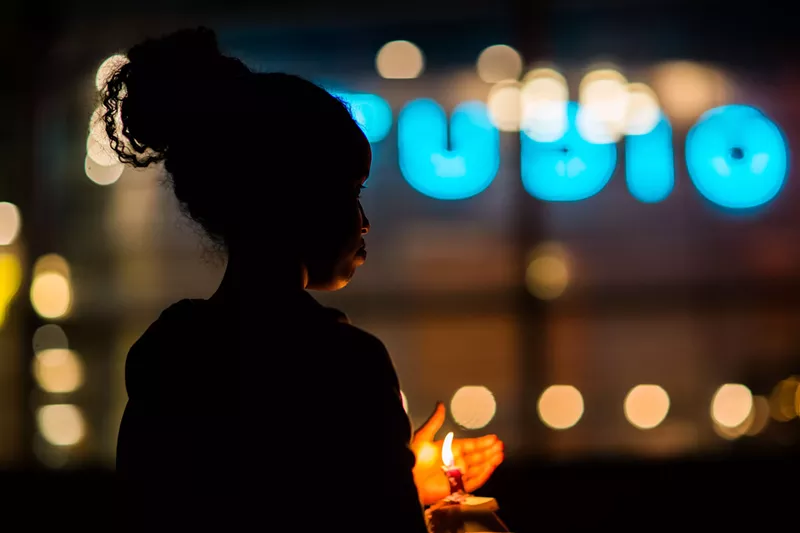 Image: Scene from an October 25, 2015, vigil in Tempe following the death of a woman and her three children at the hands of her estranged husband.