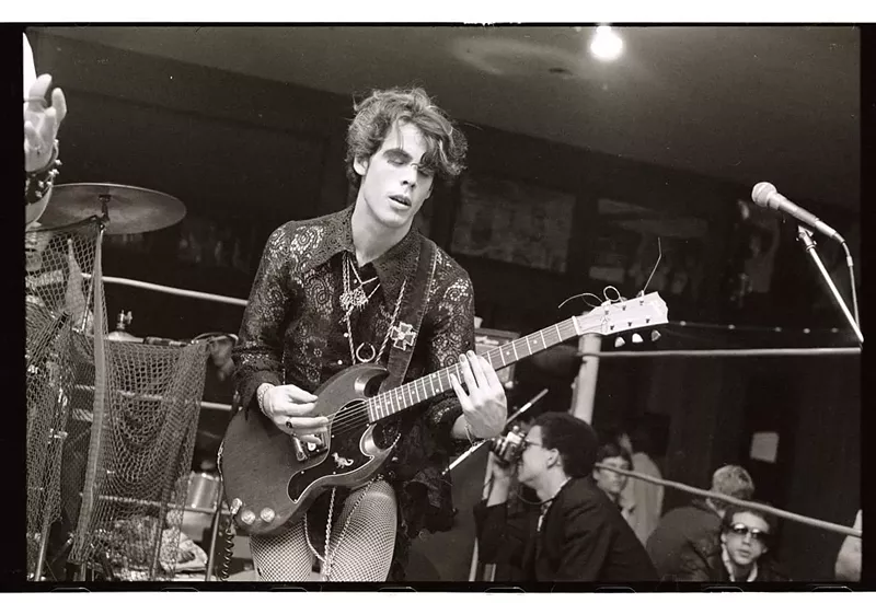 Image: Doug Clark of Mighty Sphincter plays guitar at Mad Gardens in Phoenix in the early 1980s. A young Michael Cornelius is taking pictures in the background.