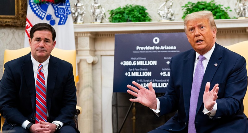 U.S. President Donald Trump meets with Arizona Gov. Doug Ducey (L) in the Oval Office of the White House on Aug. 5, 2020.