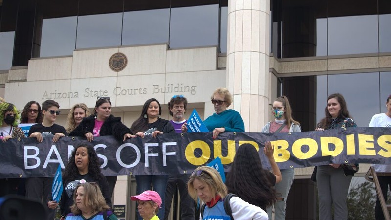 Reproductive rights advocates gathered on the steps of the Arizona Supreme Court to speak out against a near-total abortion ban from 1864 being considered by the judges on Tuesday.