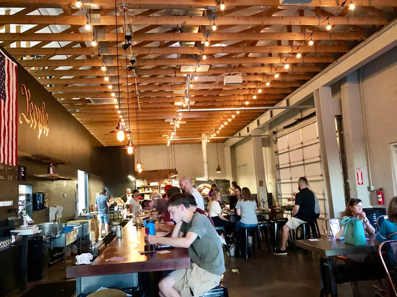 Image: The new taproom at Cider Corps with Myke's Pizza in the back.