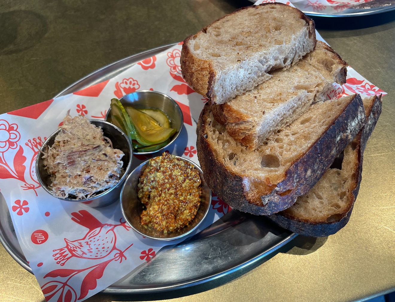 Rich pork rillettes are served with mustard, pickles and rye bread.