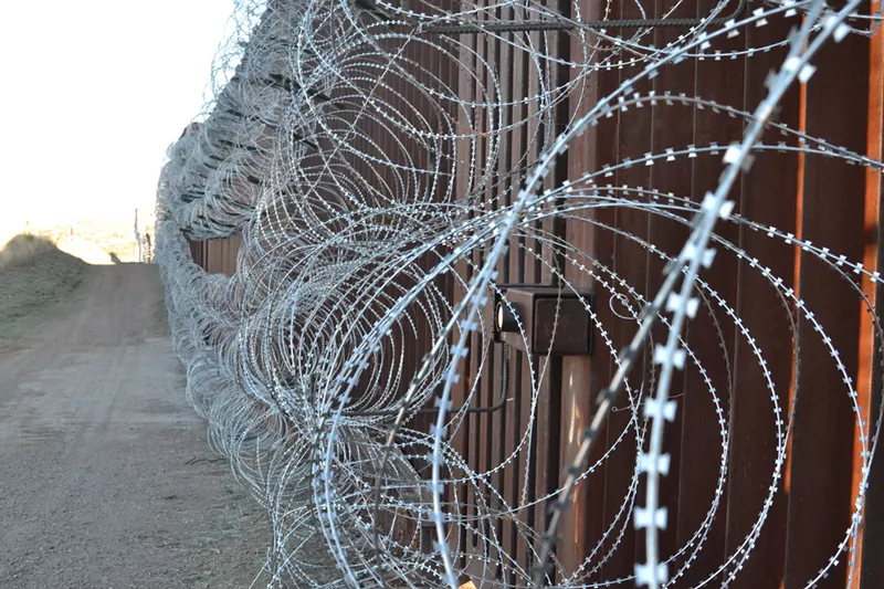 Image: The Trump administration in February installed concertina wire on the border fence separating Nogales, Arizona, and its Mexican counterpart.