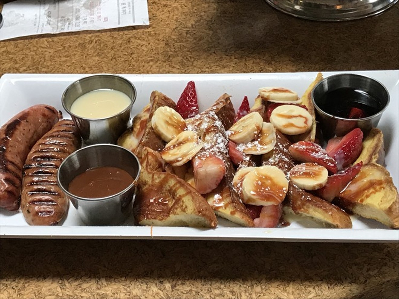 French toast with sauces and sausages.
