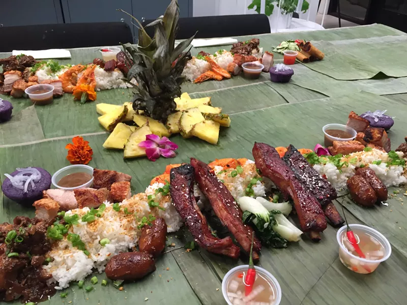 Image: Tayo's Kamayan dinner at Fuerza Local Community Kitchen in Mesa features chicken adobo, lechon kawali, longganisa, and other Filipino foods.