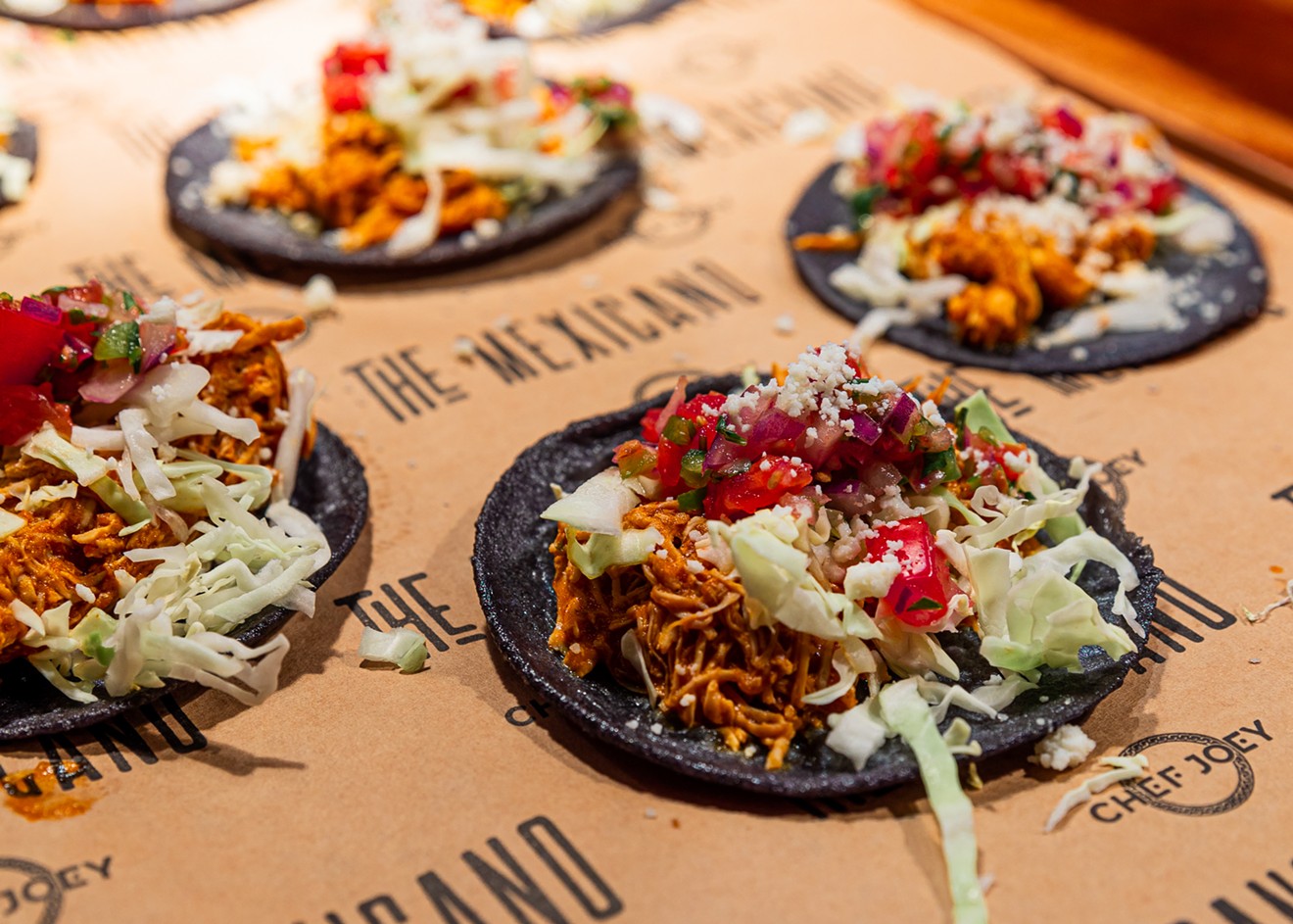 The Chicken Tinga Tacos are served on blue corn tortillas.