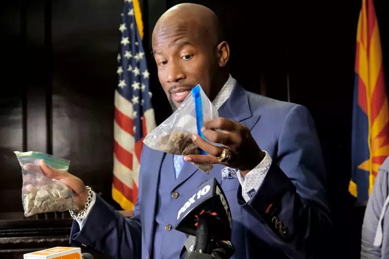 Image: Phoenix attorney Quacy Smith holds rocks similar to the ones police said Ali Osman threw at them before they shot and killed him.