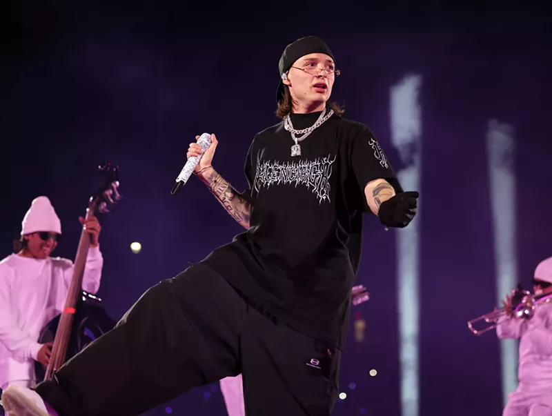 Image: A man singing onstage.