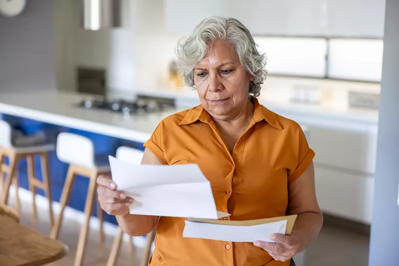 Image: a woman reading a letter