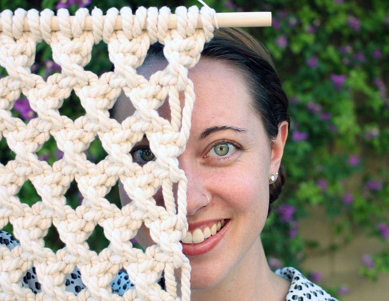 Amy Guerrero with one of her macrame wall hangings.