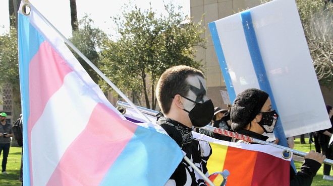 Person holding a trans pride flag