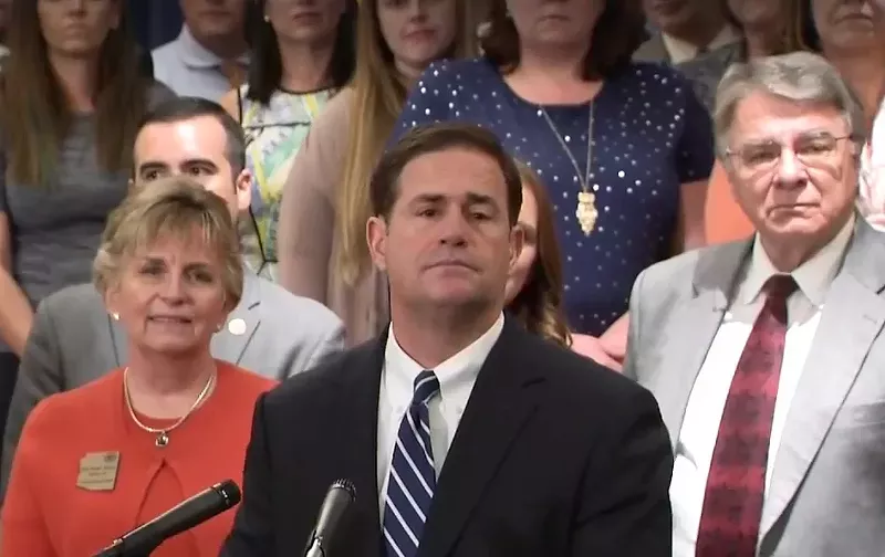Image: Governor Doug Ducey announces a teacher pay-increase plan on April 12. Ducey's proposal has produced a split reaction among the groups aligned with the #RedForEd movement.