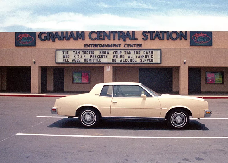 Image: Exterior photo of a nightclub with a car parked in front.