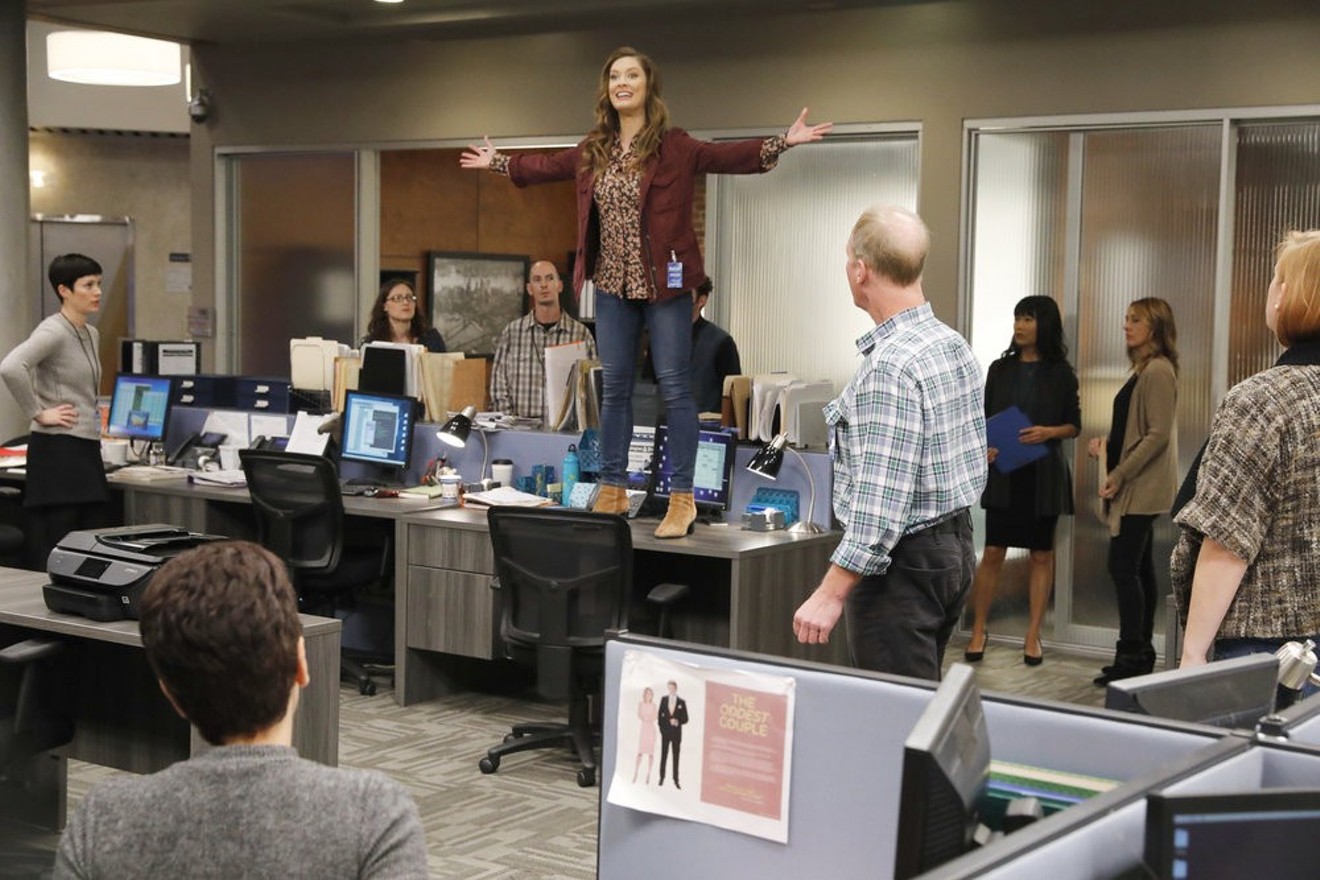 Briga Heelan (standing on desk) stars as a plucky producer working for a Jersey-based cable news station on Great News, a comedy created by former 30 Rock writer Tracey Wigfield.