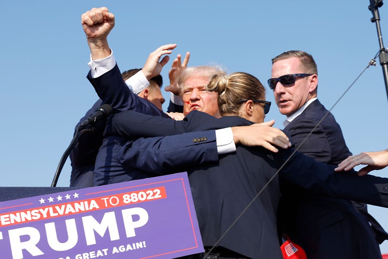 Former President Donald Trump is rushed offstage on Saturday in Pennsylvania. Butler County District Attorney Richard Goldinger said the shooter is dead after grazing Trump with a bullet, killing one audience member and injuring another in the shooting.