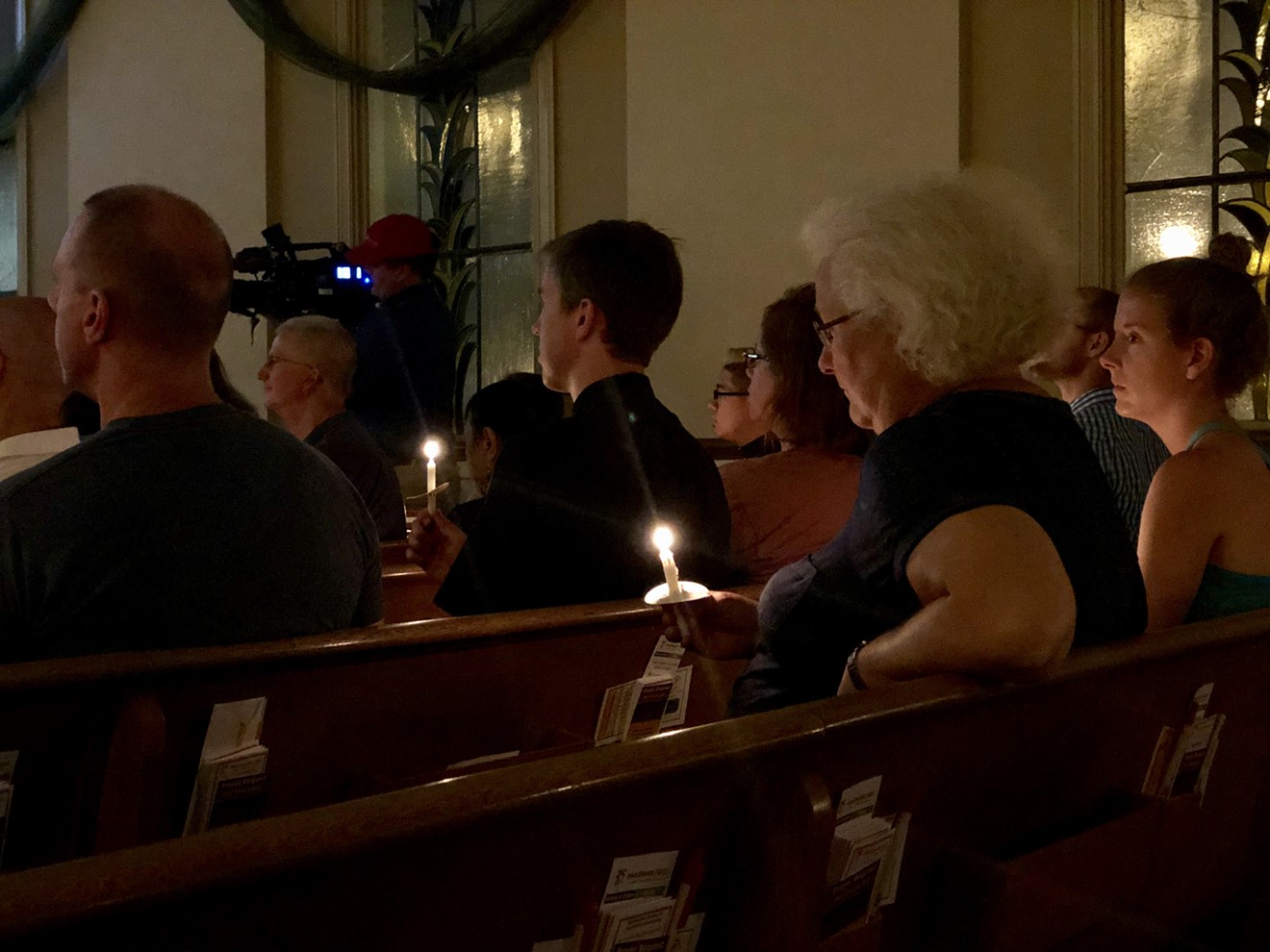 People gather at an interfaith vigil for the victims of the El Paso, Texas, and Dayton, Ohio shootings, which killed at least 29 people this weekend.