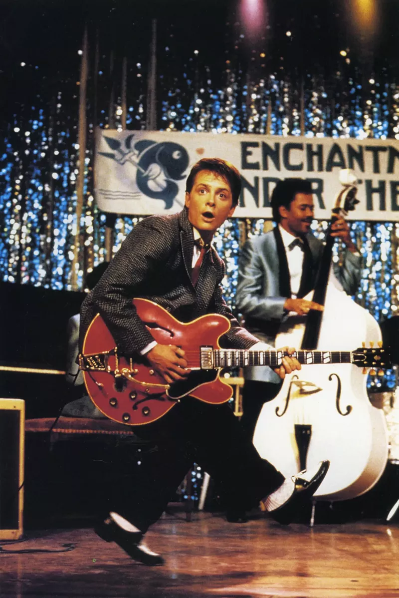 Image: Actor plays guitar in movie