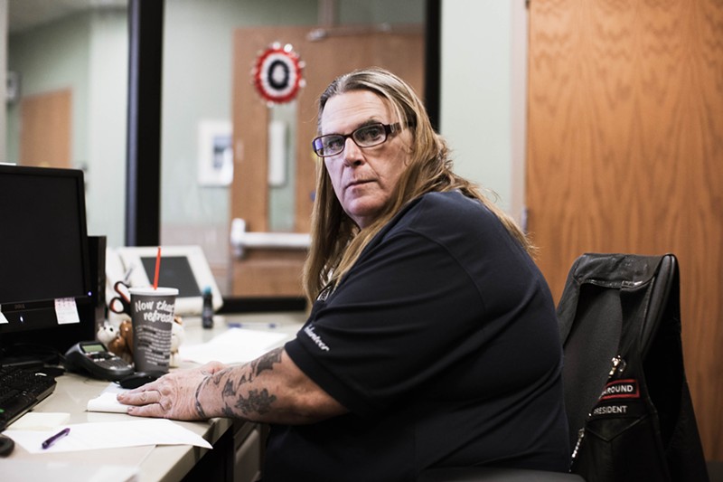 Sue McConnell sits at her desk while volunteering at the Tucson VA.