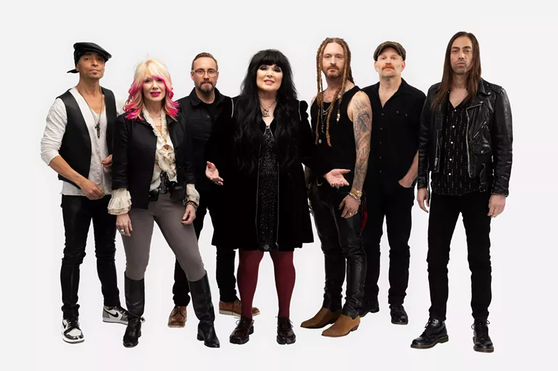 Image: A rock band of men and women.