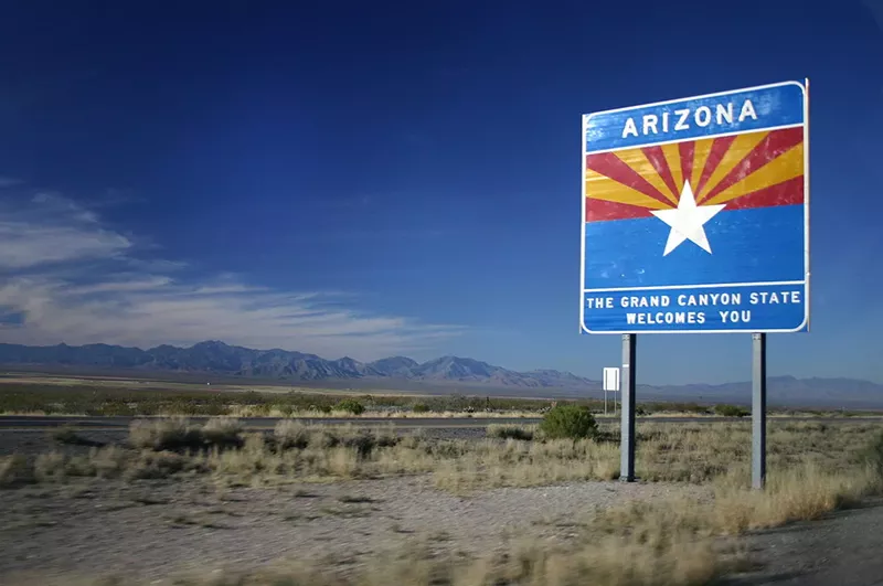 Image: A "Welcome to Arizona" sign on the highway