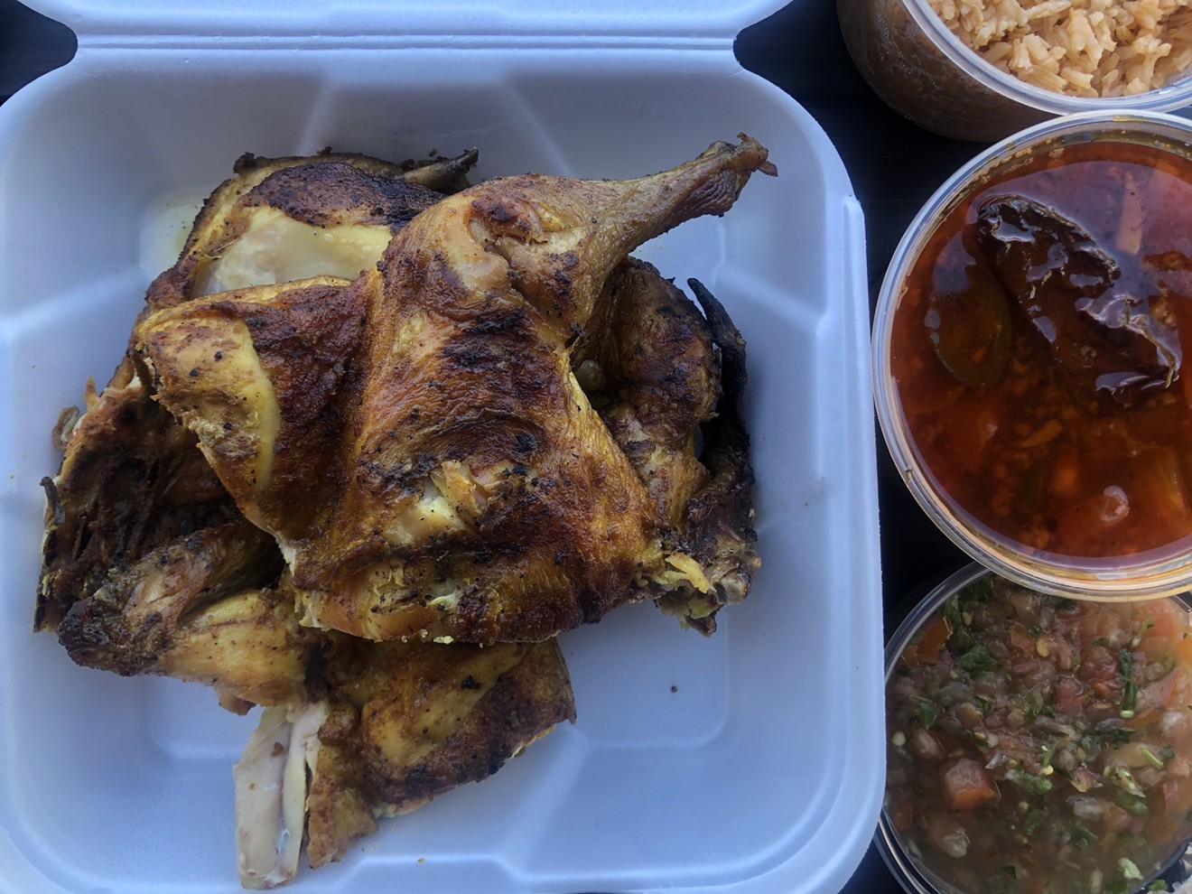 A whole Cuernavaca chicken chopped into parts, plus sides.