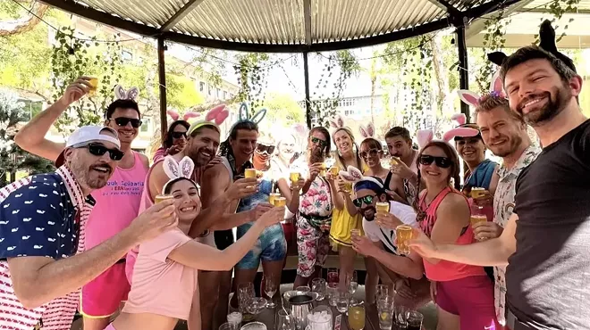 A group of young adults wearing rabbit ears.