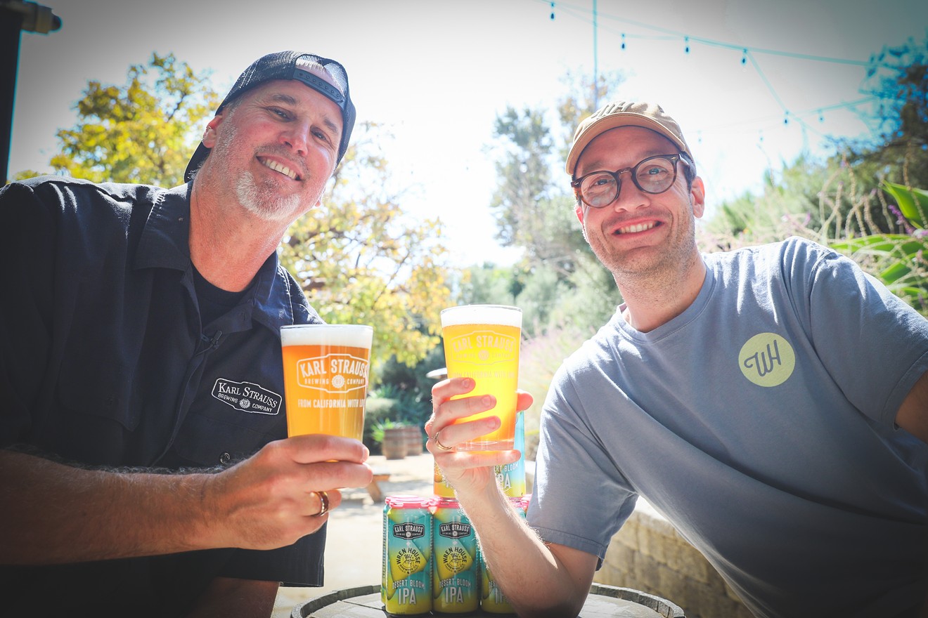 Paul Segura, brewmaster at Karl Strauss Brewing Co. and Drew Pool of Wren House Brewing Co. toast to a successful collaboration on their beer Desert Bloom IPA.