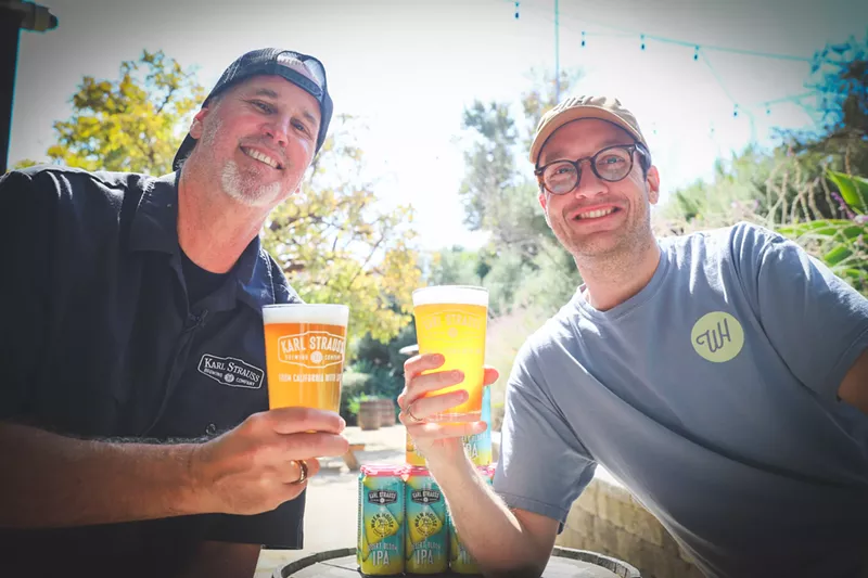 Image: Paul Segura, brewmaster at Karl Strauss Brewing Co. and Drew Pool of Wren House Brewing Co. toast to a successful collaboration on their beer Desert Bloom IPA.