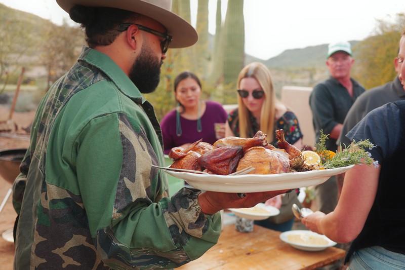 Top Arizona chefs, and me (center, back), grab platters to set the table.