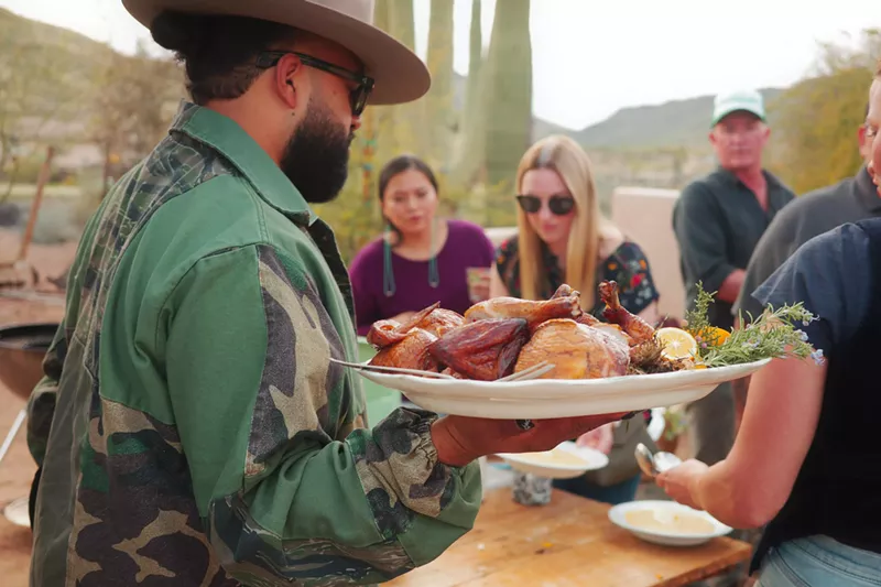Image: Top Arizona chefs, and me (center, back), grab platters to set the table.