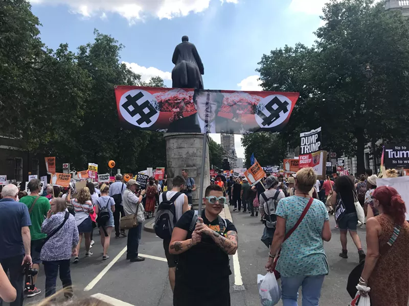 Image: Carey Methley carries the anti-Trump flag in London on Friday, July 13.