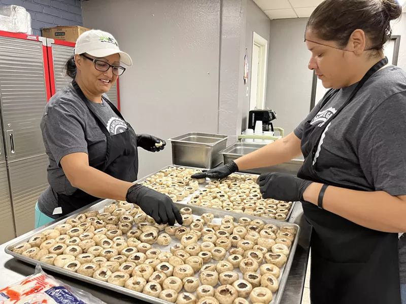 Image: Culinary students Mercedes Sandoval (left) and Sophia Leon prepare mushrooms that will be stuffed with crab and served at the program’s graduation event.