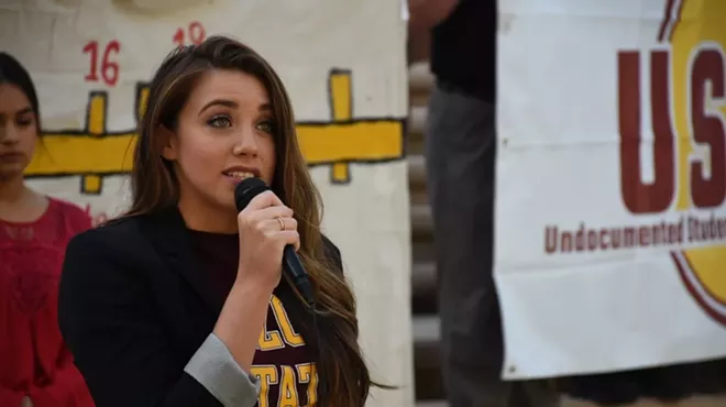 a woman speaks into a microphone