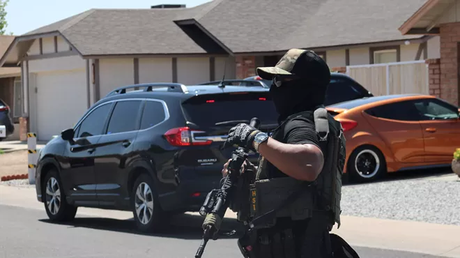 a masked HSI agent with a rifel
