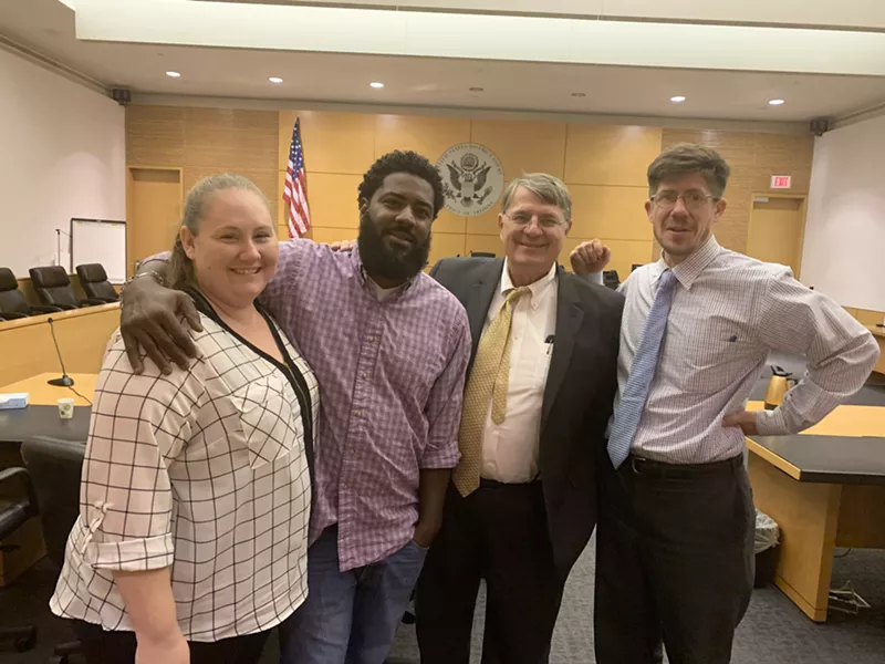 Image: Clint Lee, second from left, posed with his wife, Rachel Lee, and EEOC attorneys Bill Hobson and Ben Price after the case was settled.