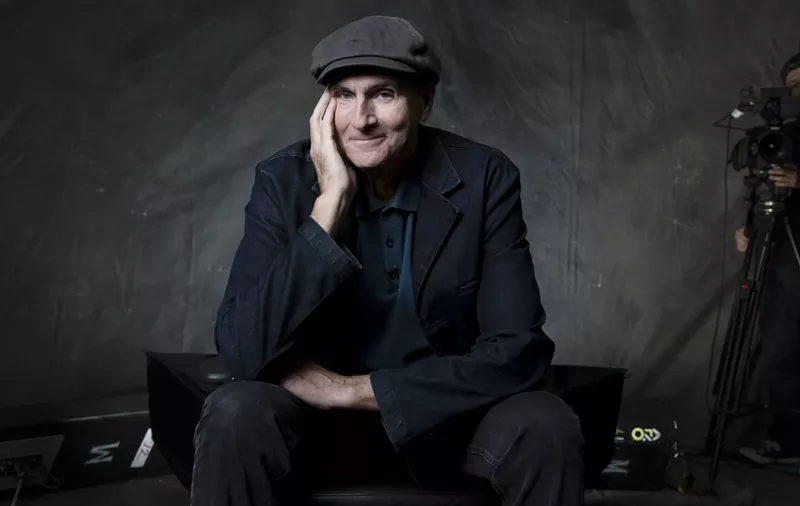 Image: A older man posing for a photo in a hat.