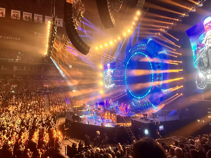 Image: A band onstage at a concert.