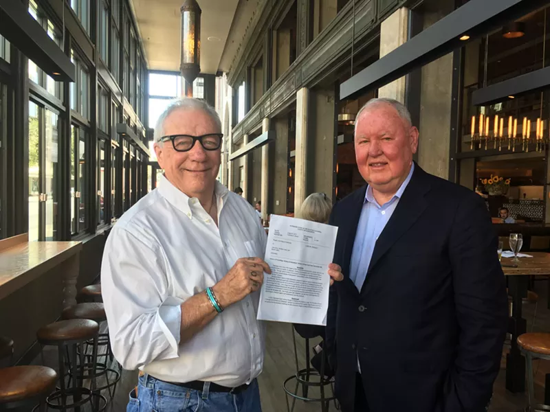 Image: Michael Lacey (left) and Jim Larkin hold up a California judge’s order in August 2017 tossing out criminal charges against them.