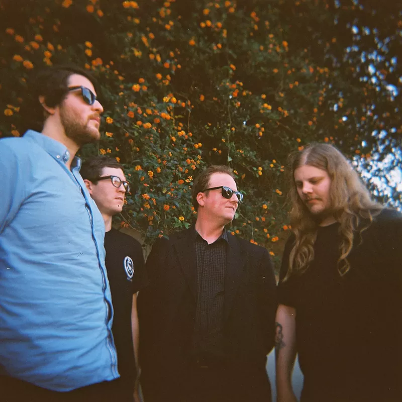 Image: Protomartyr is pictured with Joe Casey at the center.