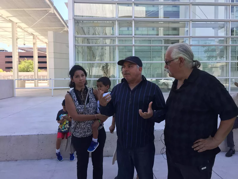 Image: Angeles Maldonado, Raul Cordero, and Salvador Reza discuss former Maricopa County Sheriff Joe Arpaio's contempt-of-court conviction outside of the federal courthouse in Phoenix on Monday.