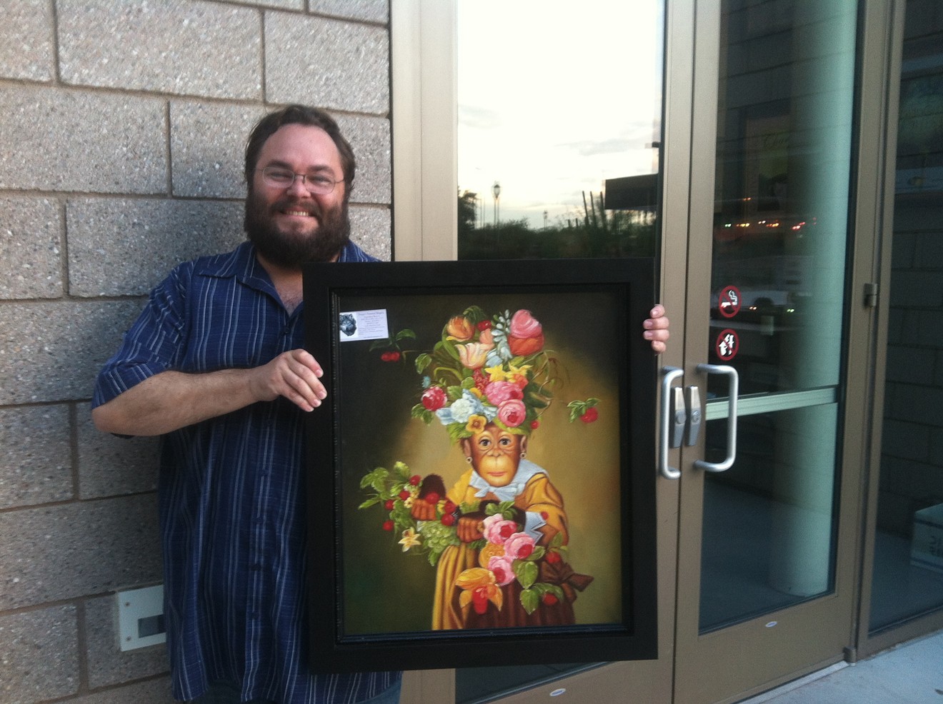 Kerry Lengel with artwork by Donald Roller Wilson for a 2015 silent auction in Peoria.