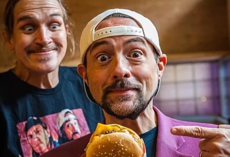 Image: Kevin Smith (center) with a Cow Tipper burger from his Mooby's pop-up restaurant.