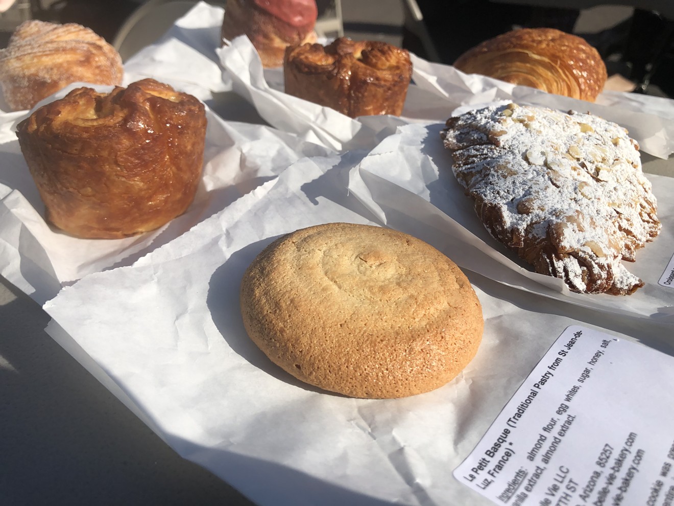 A spread of French pastries. The Le Petit Basque and almond croissant, front and right, course with intense almond flavor.