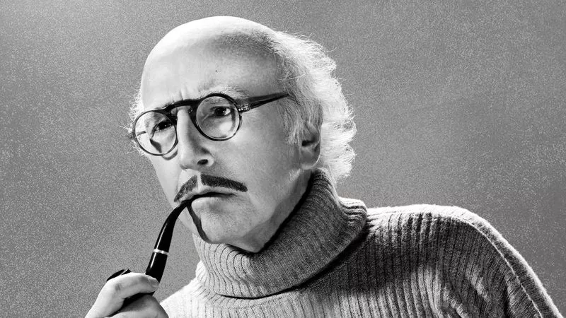 Image: Black and white photo of Larry David with a mustache and pipe.