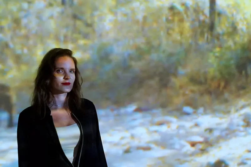 Image: Artist Lauren Strohacker with one of several video installations addressing Northern Jaguars in the borderlands.