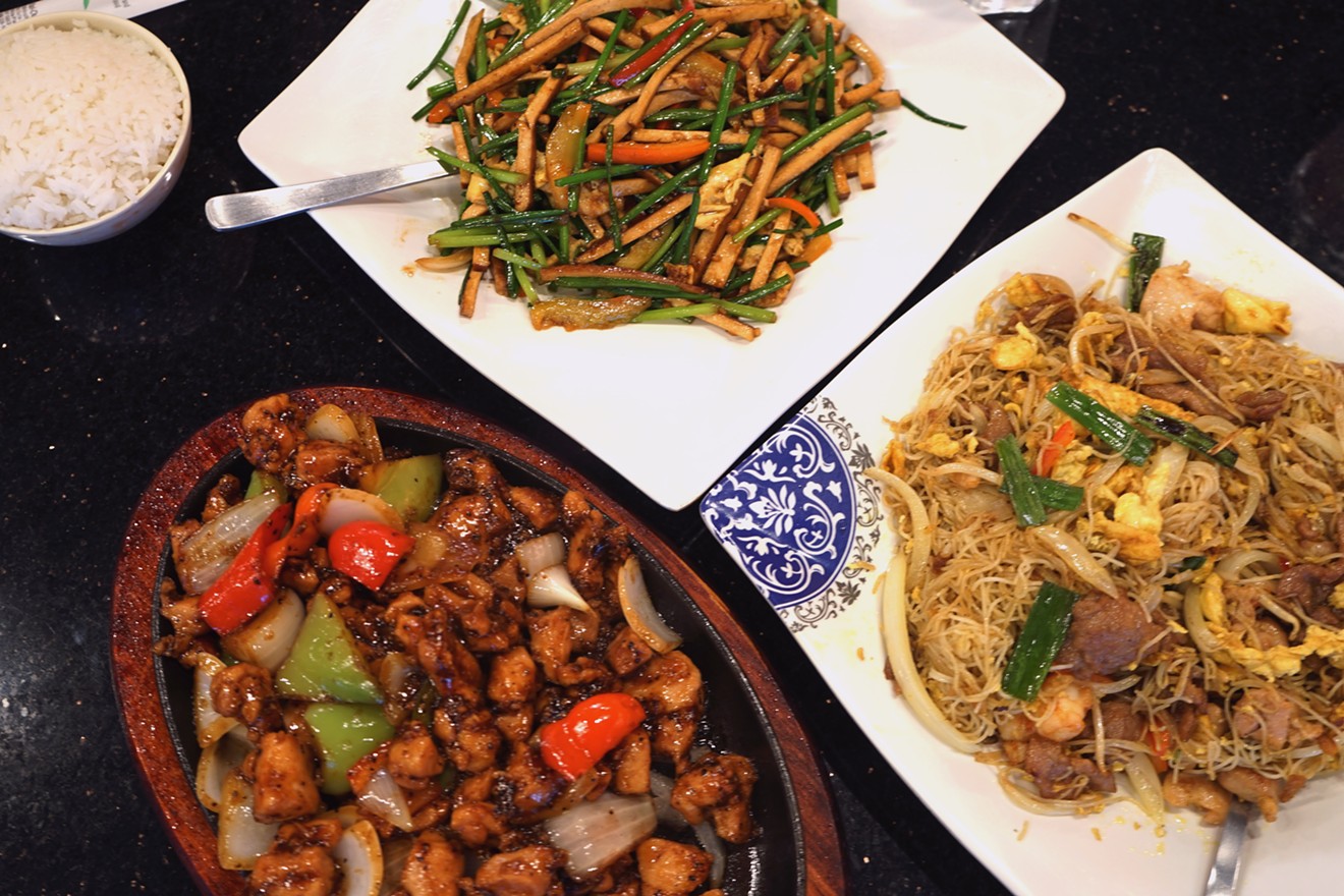 Dishes on the English-language menu include (clockwise from top) bean curd with sliced egg and chives, Singapore noodle, and black pepper chicken on hot iron.