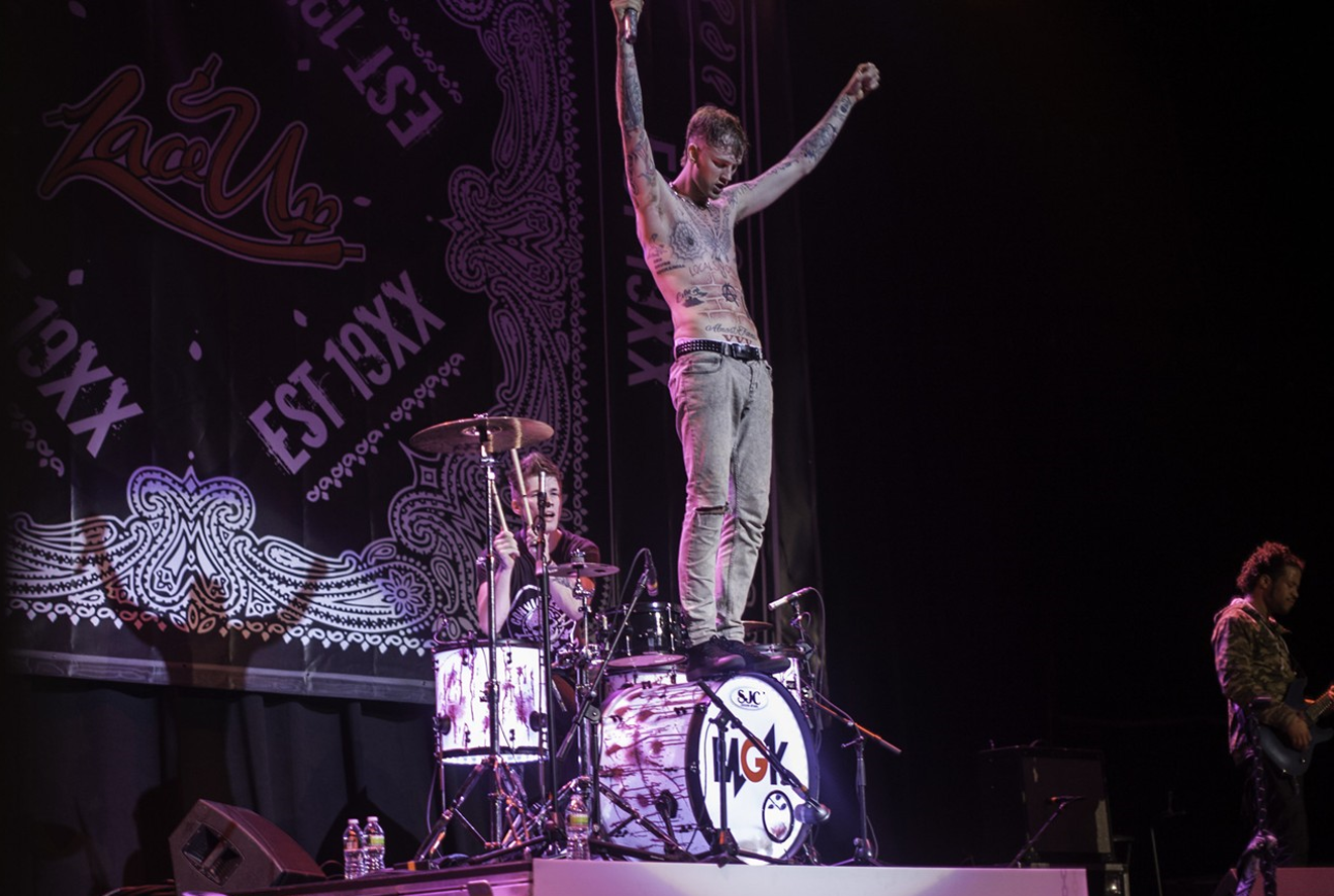 Machine Gun Kelly stands tall at a 2013 concert in Boston.