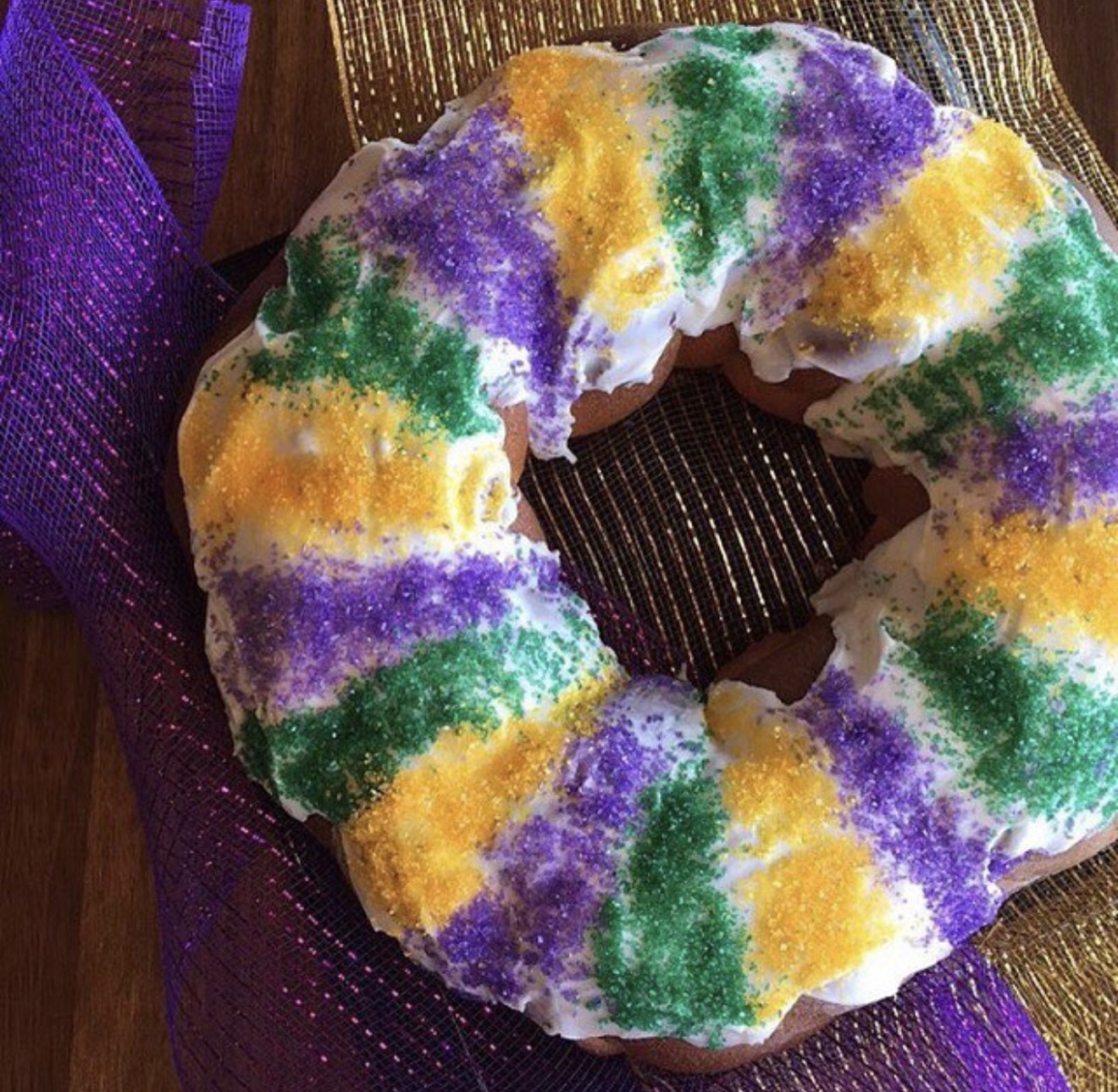 Snack on King Cake, a Fat Tuesday favorite made with cinnamon brioche and glazed with icing and colorful sprinkles.