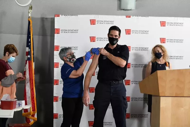 Image: A Mesa firefighter receives a second dose of the COVID-19 vaccine.